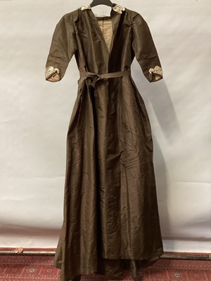 Lot 2115 - 1834 Georgian brown silk dress, possibly maternity dress with pleats let out at the front, high waist with silk ribbon tie, simple elbow lenght sleeves , Honiton lace trims.