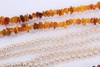 Lot 864 - Two amber bead necklaces, cultured pearl necklace with silver clasp and one other simulated pearl necklace (4)