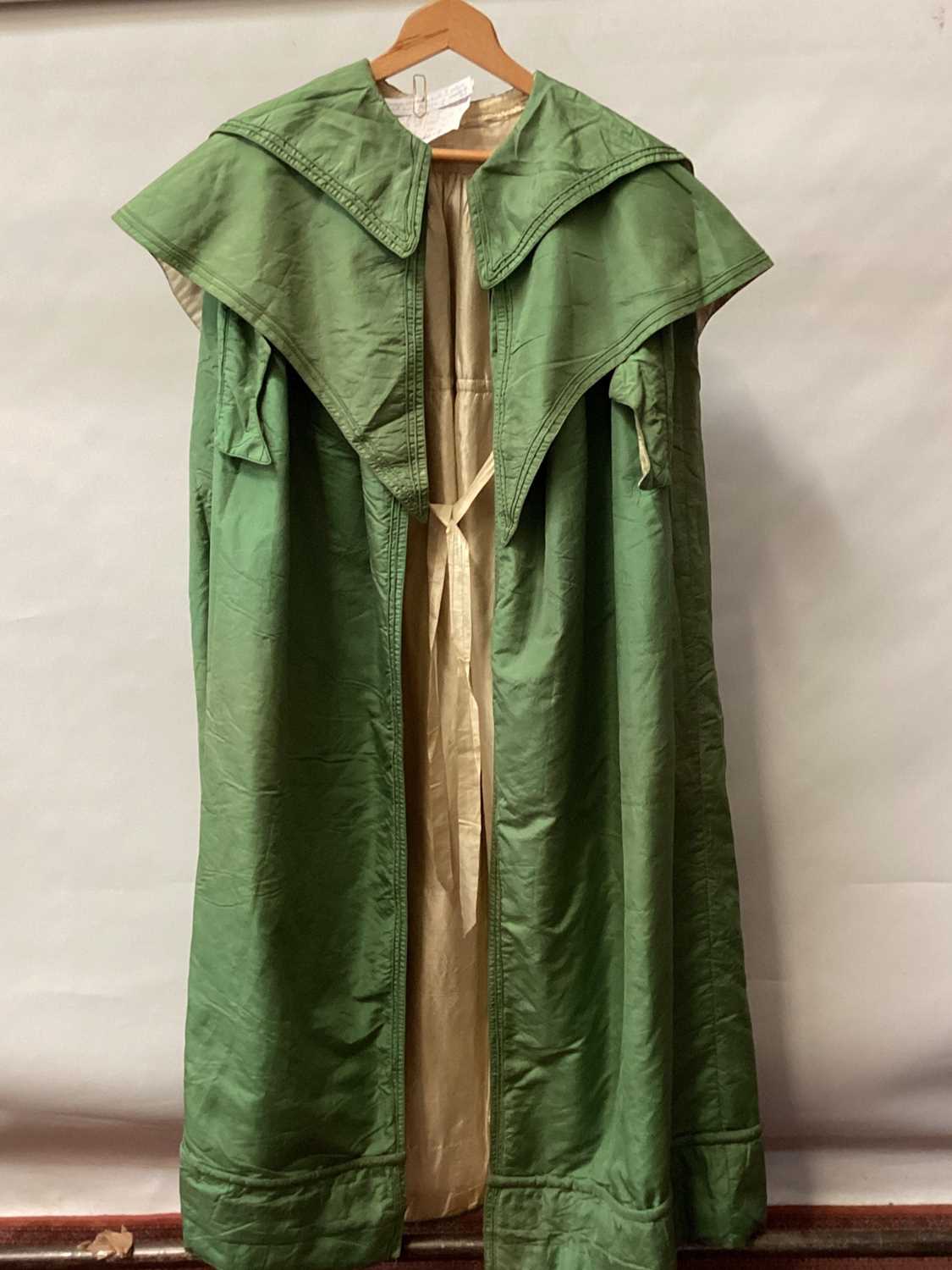 Lot 2116 - 1835 Georgian green silk cloak with double collar and lined with cream silk, padded hemline .