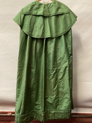 Lot 2116 - 1835 Georgian green silk cloak with double collar and lined with cream silk, padded hemline .