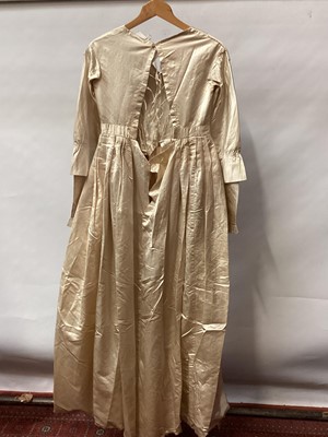 Lot 2117 - 1845 Victorian wedding dress in cream silk folded pleats on boned bodice with pointed waistline, two tier sleeves, detachable large bow to be worn at the waist, matching short cape silk cape trimme...