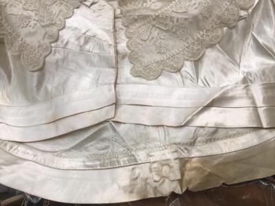 Lot 2117 - 1845 Victorian wedding dress in cream silk folded pleats on boned bodice with pointed waistline, two tier sleeves, detachable large bow to be worn at the waist, matching short cape silk cape trimme...