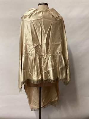 Lot 2117 - 1845 Victorian wedding dress in cream silk folded pleats on boned bodice with pointed waistline, two tier sleeves, detachable large bow to be worn at the waist, matching short cape silk cape trimme...