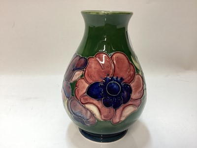 Lot 1252 - Moorcroft pottery vase decorated in the Anemone pattern on green ground, original paper label to base - Potters To The Late Queen Mary, 13.5cm high