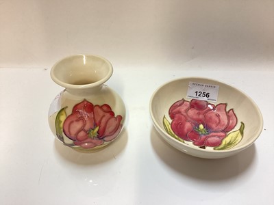 Lot 1256 - Four pieces of Moorcroft pottery to include a vase, small bowl, tray and oval dish, all with impressed marks