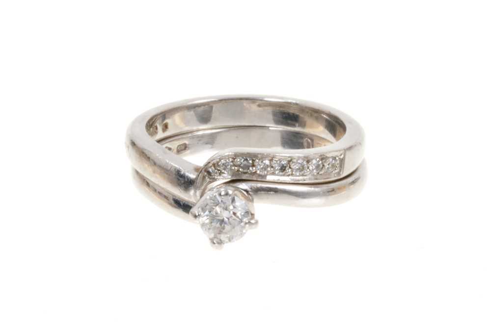 Lot 470 - Diamond single stone ring with a round brilliant cut diamond weighing approximately 0.33cts in platinum crossover setting, together with a matching diamond set band (2)