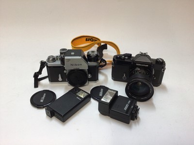 Lot 2369 - Nikon F 35mm SLR camera, together with a Nikomat FT2, lens and two flashes