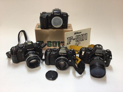 Lot 2370 - Four Nikon F series SLR cameras, including 2 x F-501 AF with lenses, one F-301 with lens, and one F-601 body in original box