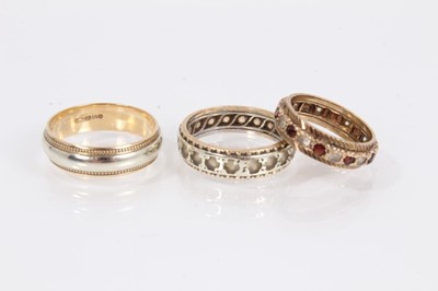 Lot 898 - 9ct yellow and white gold wedding ring, 9ct gold gem set eternity ring and a 9ct gold and silver gem set eternity ring (3)