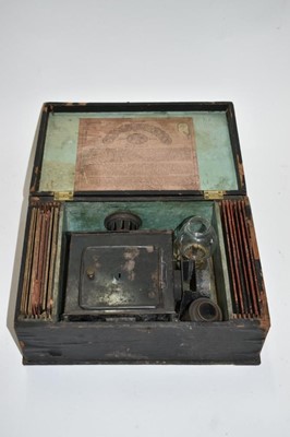 Lot 2439 - Antique German magic lantern in case with slides - original trade label to inside of case