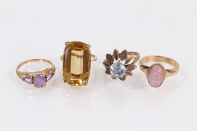 Lot 904 - 9ct gold large citrine cocktail ring, two other 9ct gold gem set dress rings and a yellow metal opalescent cabochon ring (4)