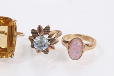 Lot 904 - 9ct gold large citrine cocktail ring, two other 9ct gold gem set dress rings and a yellow metal opalescent cabochon ring (4)