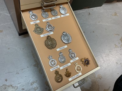 Lot 622 - Thirty draws containing a well presented collection of British Police badges and insignia with annotations, contained in a metal filing cabinet.