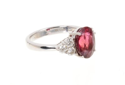 Lot 428 - Pink tourmaline and diamond ring with an oval mixed cut pink tourmaline weighing approximately 3.29cts flanked by six brilliant cut diamonds in claw setting on 18ct white gold shank. Estimated tota...