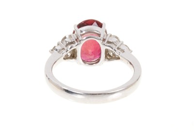 Lot 428 - Pink tourmaline and diamond ring with an oval mixed cut pink tourmaline weighing approximately 3.29cts flanked by six brilliant cut diamonds in claw setting on 18ct white gold shank. Estimated tota...