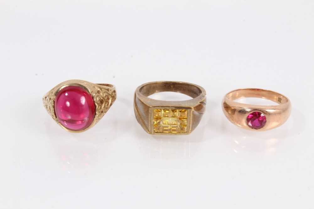 Lot 911 - 9ct gold red cabochon ring, 9ct gold red synthetic stone ring and 9ct gold yellow synthetic stone ring (3)