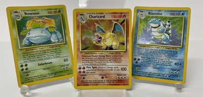 Lot 1521 - Pokémon cards to include rare base set Wizards of the coast Charizard 4/102 in very good condition with fourteen other Holographic Cards and others