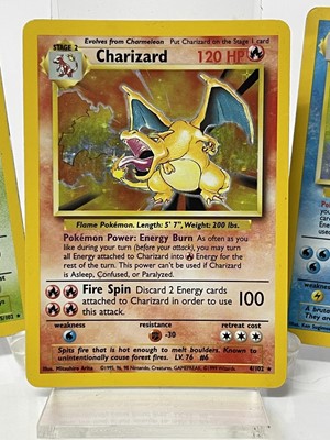 Lot 1521 - Pokémon cards to include rare base set Wizards of the coast Charizard 4/102 in very good condition with fourteen other Holographic Cards and others