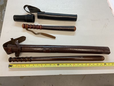 Lot 620 - Two mounted Police batons in leather sheaths and lot truncheons