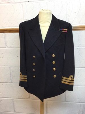 Lot 630 - Royal Navy Commanders Service dress jacket with mounted medal ribbons for Distinguished Service Cross, 1939 - 1945 Star, Africa Star, Burma Star and War medal, with original Gieves label to interio...