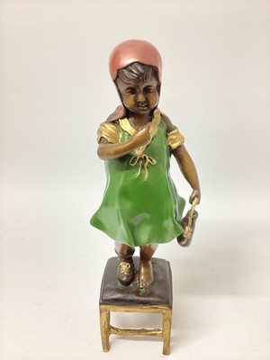 Lot 2482 - A painted bronze figure of a girl standing on a stool, 14½" high