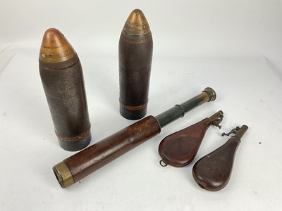 Lot 651 - Two 19th century leather shot flasks, together with two shells and a leather covered brass scope by Broadhurst Clarkson & Co Ltd.