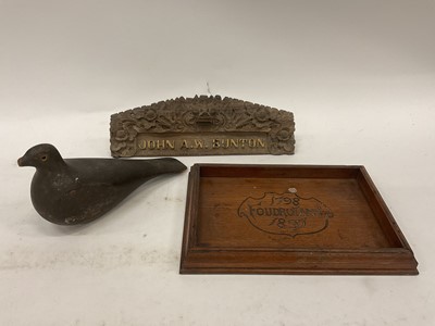 Lot 2501 - A carved and painted decoy pigeon, a carved oak tray dated 1897, and an Eastern carved nameplate (3)