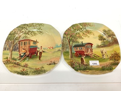 Lot 1292 - Two porcelain plates painted with gypsy caravans, signed L.V. Norwood