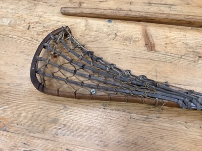 Lot 2502 - Two old lacrosse sticks and an old discus (3)