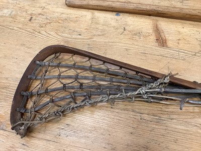 Lot 2502 - Two old lacrosse sticks and an old discus (3)