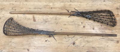 Lot 2502 - Two old lacrosse sticks and an old discus (3)