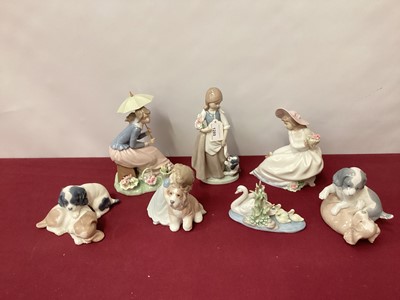 Lot 1289 - Six Nao porcelain figures and dogs, together with a Lladro swan with cygnets (7)