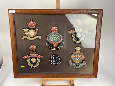 Lot 672 - Group of five hand embroidered military badges for the Grenadier Guards, Hampshire regiment and others, with another badge 'New Year Greetings 1926