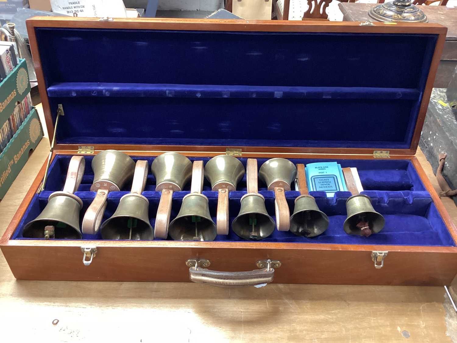 Lot 2219 - Set of ten handbells in fitted case