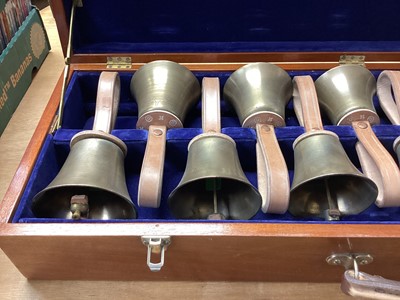 Lot 2219 - Set of ten handbells in fitted case