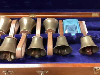 Lot 2219 - Set of ten handbells in fitted case