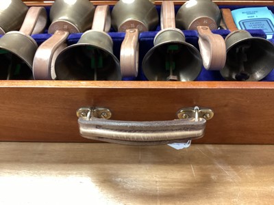 Lot 2219 - Set of ten handbells in fitted case