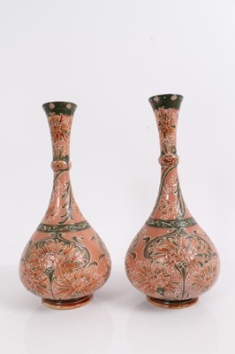 Lot 1306 - William Moorcroft for James Macintyre, a pair of Florian Ware cornflower vases, circa 1905, each of bottle form with knopped flared neck, with tube-lined cornflower design on green and salmon pink...