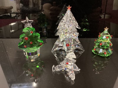 Lot 1325 - Three Swarovski crystal Christmas Trees together with a Clown, all boxed (4)