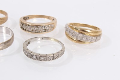 Lot 988 - Five 9ct gold rings to include three diamond set half eternity style rings, diamond set buckle ring and a wedding band