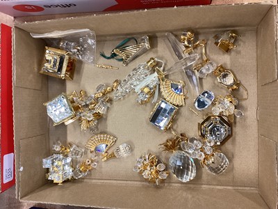 Lot 1333 - Collection of unboxed Swarovski crystal and gold coloured miniature items including buildings, rocking chair, rocking horse, golf clubs, prams etc (approximately 60 items)