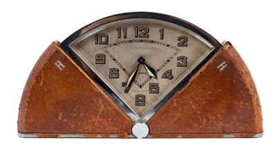 Lot 653 - Art Deco travel clock by Finnigans in chrome and leather fan shape case