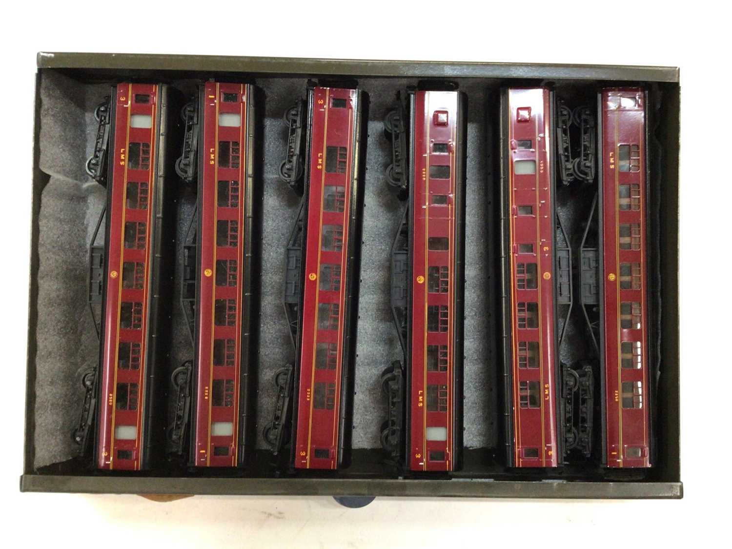 Lot 1866 - Railway OO gauge selection of Exley tinplate carriages housed in metal cabinet various lines including Great Western, L.M.S., and others (28)