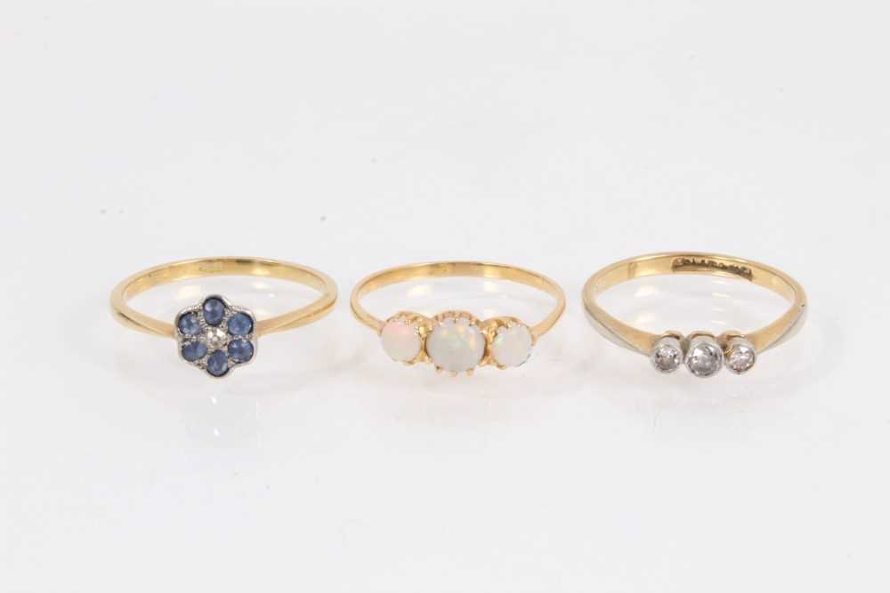 Lot 1064 - Edwardian diamond three stone ring, 18ct gold sapphire and diamond flower head ring and opal three stone ring (3)