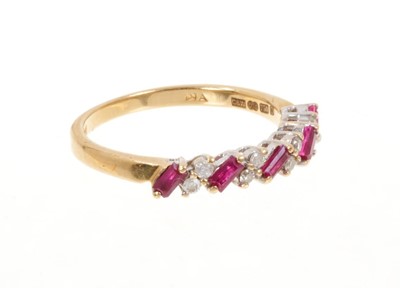 Lot 447 - Ruby and diamond eternity ring with a half hoop of rectangular step cut rubies interspaced by pair of brilliant cut diamonds in 18ct gold setting.
