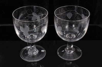 Lot 25 - A group of six 19th century glasses, including a pair of large goblets engraved with hops and barley, a pair of rummers on square bases engraved with grapevines, an unusual glass with spout, and an...