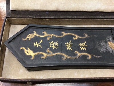 Lot 11 - Chinese carved inkstone of lozenge form, carved with mythical beasts, 28cm long, in case