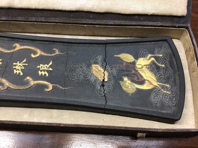 Lot 11 - Chinese carved inkstone of lozenge form, carved with mythical beasts, 28cm long, in case