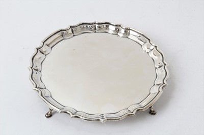 Lot 208 - Georgian-style silver salver with moulded border raised on four pad feet