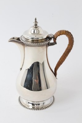 Lot 210 - Georgian-style hot water pot with caned handle and gadrooned borders